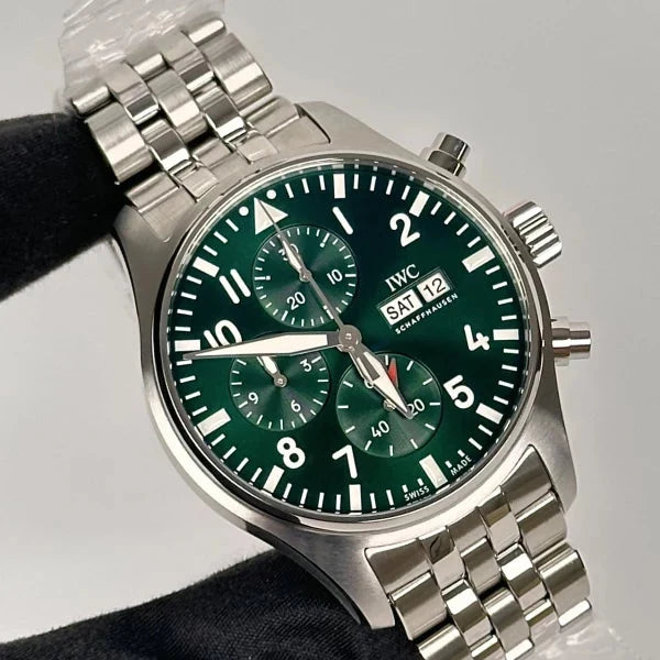 Silver watch with a green face on a black background